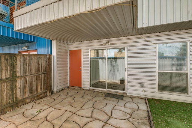 property entrance featuring a patio area and fence