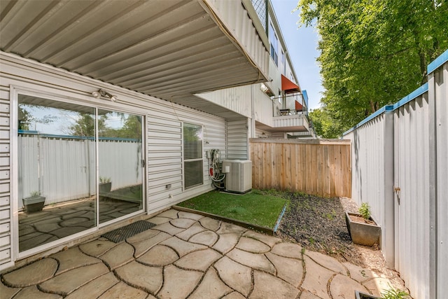 view of patio / terrace featuring central air condition unit and a fenced backyard