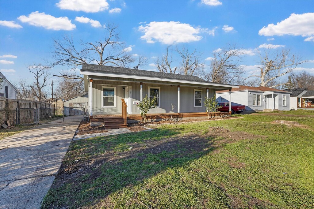 1529 Axe Dr, Garland, TX 75041 - view of front of house featuring a gate, covered porch, a front lawn, and fence