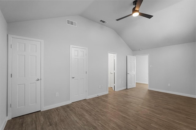 unfurnished bedroom with visible vents, baseboards, wood finished floors, and vaulted ceiling