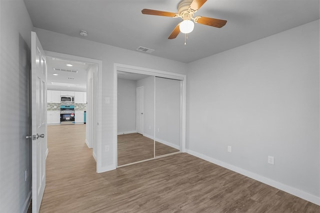 unfurnished bedroom with a closet, visible vents, and light wood finished floors