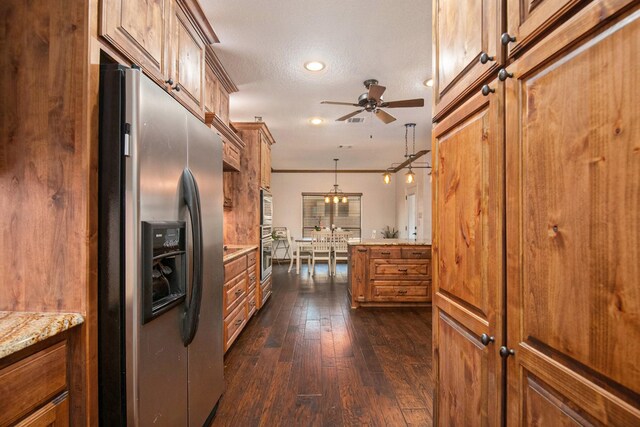 kitchen with dark wood-style floors, ceiling fan, stainless steel refrigerator with ice dispenser, a textured ceiling, and brown cabinets