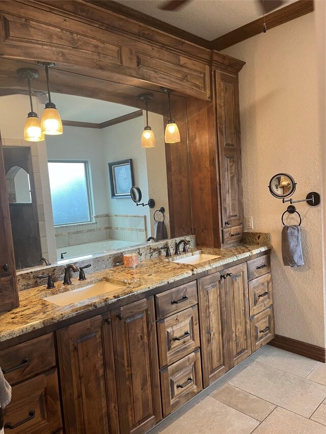 full bath featuring a garden tub, ornamental molding, baseboards, and a sink