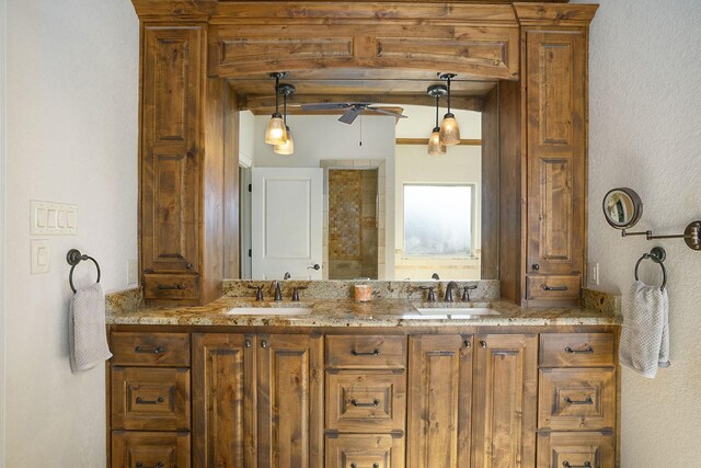 bathroom featuring double vanity, beamed ceiling, a ceiling fan, and a sink