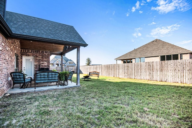 view of yard featuring a patio area and a fenced backyard