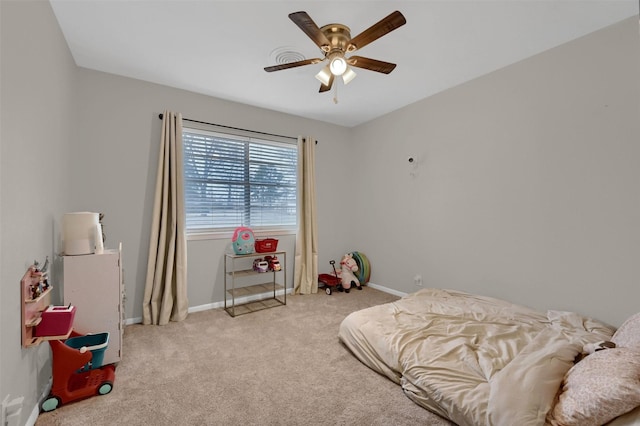 bedroom featuring baseboards, light carpet, and a ceiling fan