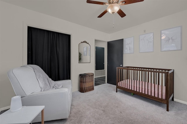 carpeted bedroom with a ceiling fan and baseboards