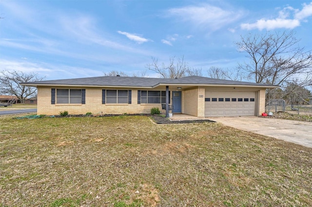 ranch-style home with brick siding, an attached garage, concrete driveway, and a front lawn