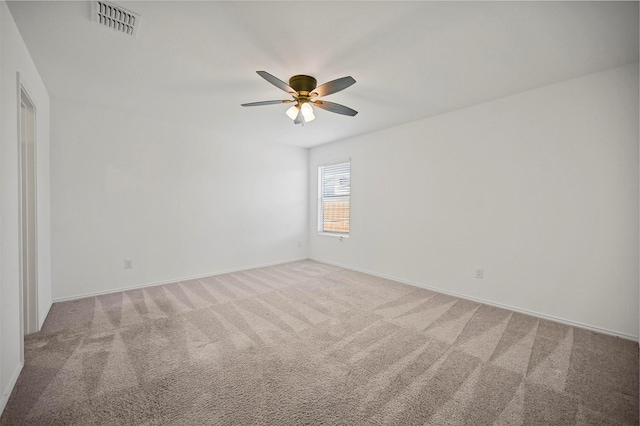 empty room featuring visible vents, baseboards, ceiling fan, and carpet floors