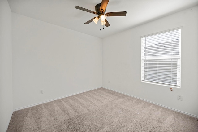 empty room with ceiling fan and carpet