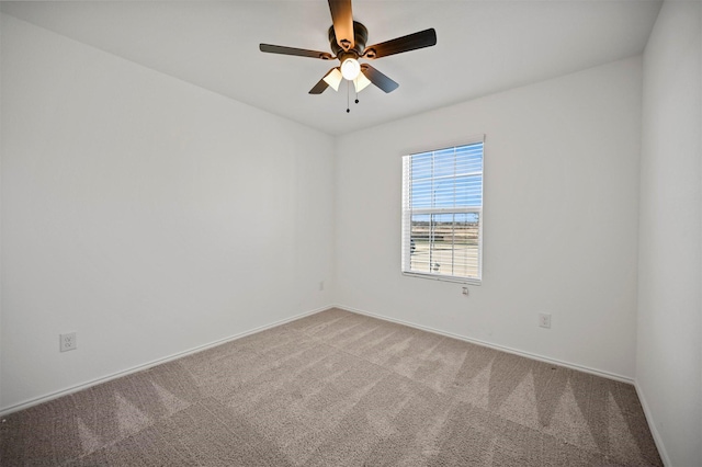 unfurnished room featuring carpet, baseboards, and ceiling fan