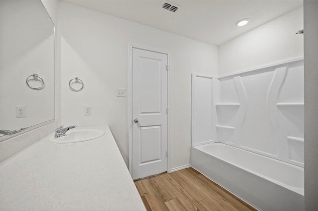 bathroom with visible vents, vanity, and wood finished floors