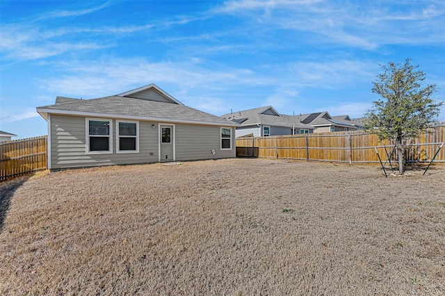 back of house with a fenced backyard