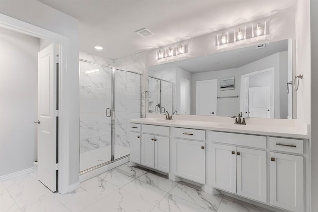 full bath featuring a marble finish shower, visible vents, marble finish floor, and a sink