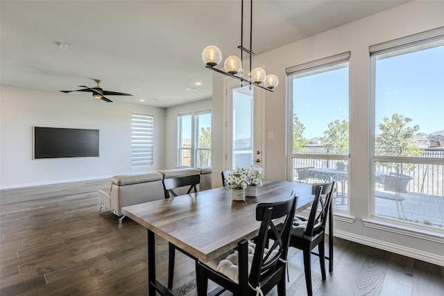 dining space with recessed lighting, baseboards, dark wood finished floors, and ceiling fan with notable chandelier