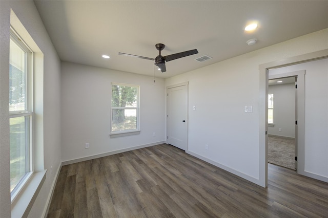 unfurnished bedroom featuring visible vents, baseboards, and wood finished floors