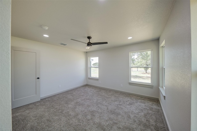 carpeted empty room with recessed lighting, visible vents, baseboards, and a ceiling fan