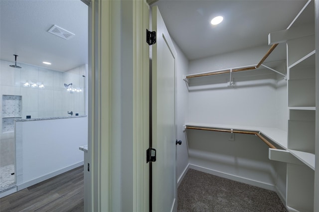 spacious closet with wood finished floors and visible vents