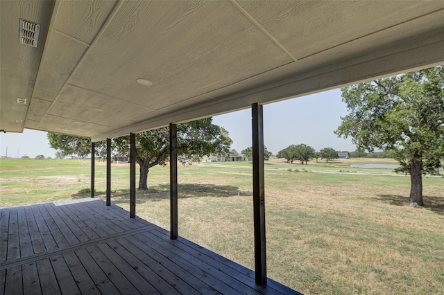 wooden terrace with a lawn