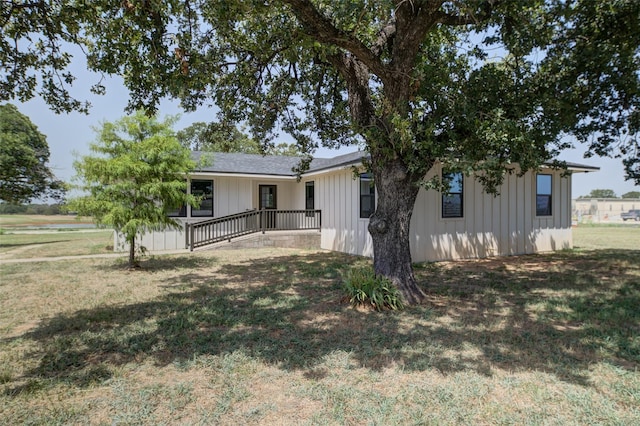 view of front of property featuring board and batten siding and a front yard