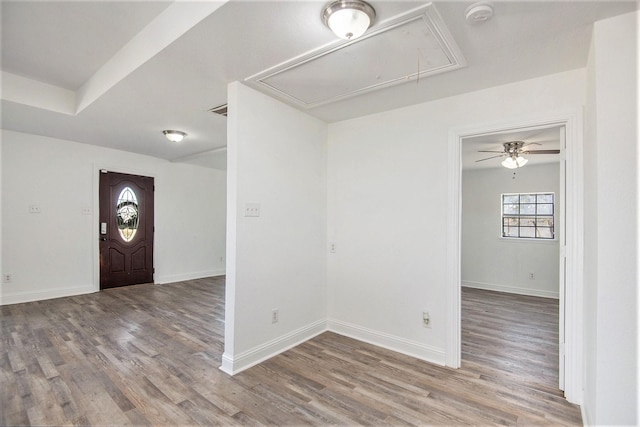 entryway featuring baseboards and wood finished floors