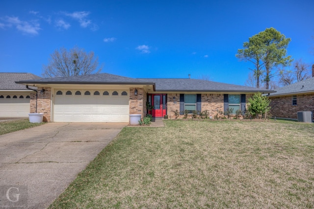 ranch-style house featuring a shingled roof, concrete driveway, an attached garage, a front yard, and brick siding