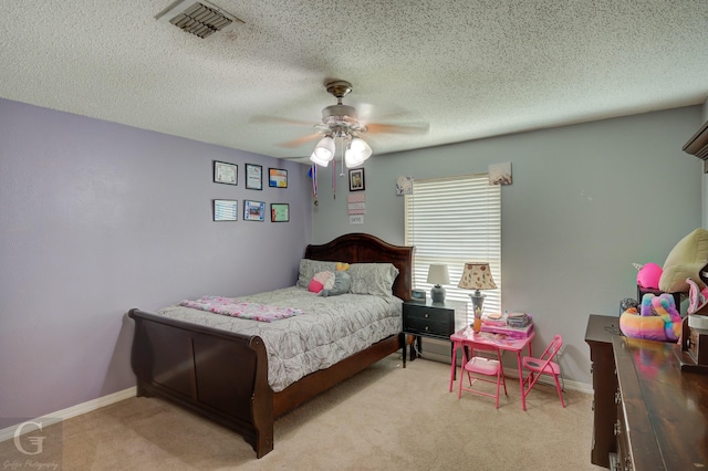 carpeted bedroom with baseboards, visible vents, and a textured ceiling