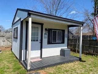 view of outbuilding with an outdoor structure and fence