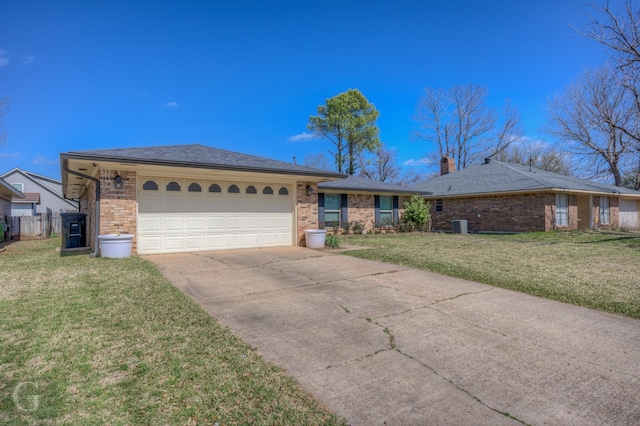 ranch-style home with driveway, an attached garage, a chimney, a front lawn, and brick siding