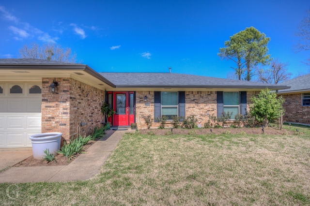 single story home featuring brick siding, a front yard, and a garage