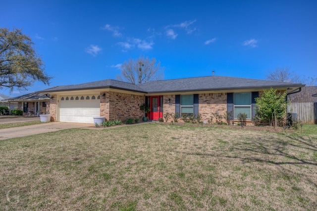 ranch-style home with brick siding, an attached garage, driveway, and a front yard