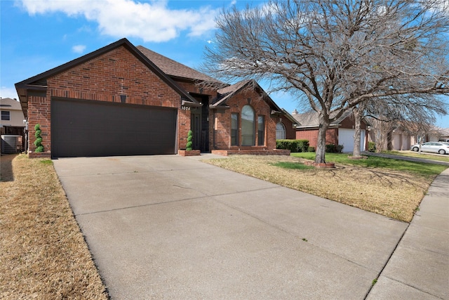 view of front of house featuring a front yard, a garage, brick siding, and concrete driveway