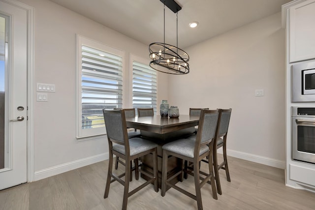 dining area featuring a chandelier, recessed lighting, light wood-type flooring, and baseboards