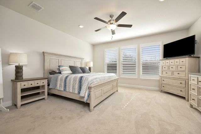 bedroom featuring light carpet, visible vents, a ceiling fan, and baseboards