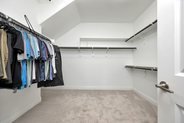 spacious closet with vaulted ceiling and carpet floors