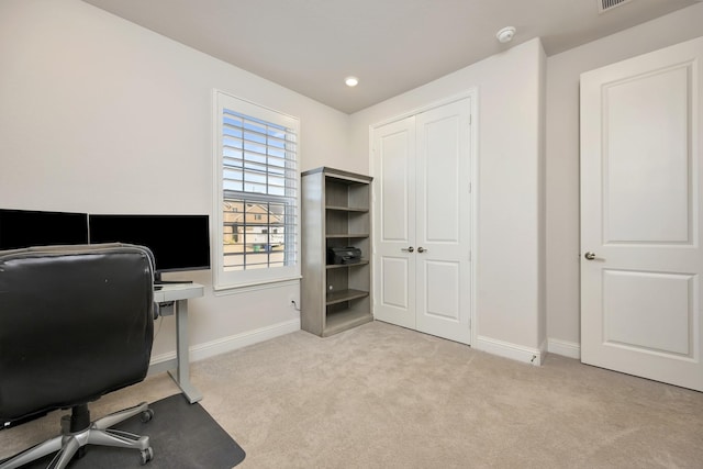 carpeted home office with baseboards