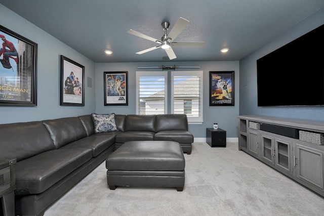 living area featuring baseboards, recessed lighting, ceiling fan, a textured ceiling, and light carpet