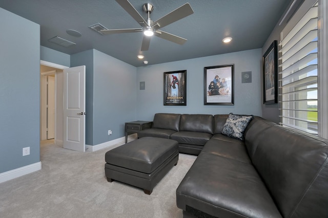 carpeted living room with visible vents, baseboards, and ceiling fan