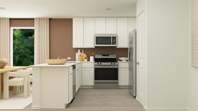 kitchen with light wood finished floors, a peninsula, stainless steel appliances, light countertops, and white cabinets