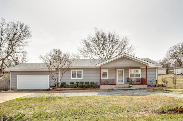 ranch-style home featuring a front yard, fence, a porch, an attached garage, and concrete driveway