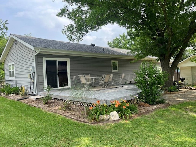 751 E Cooper St, Van Alstyne, TX 75495 - rear view of property with a deck, a lawn, outdoor dining area, and a shingled roof