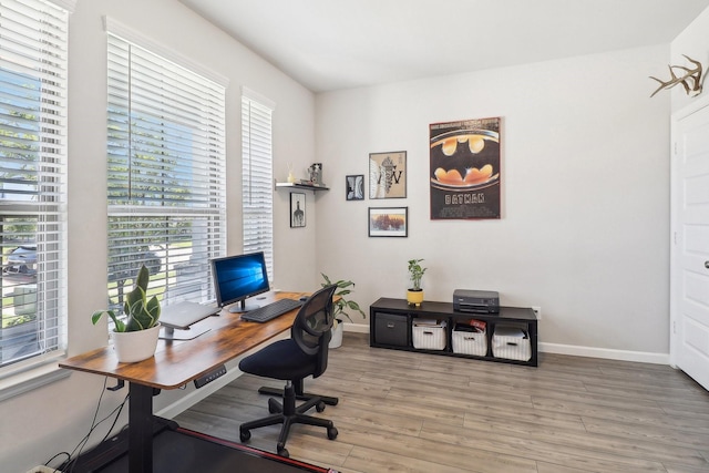 office area featuring baseboards and wood finished floors