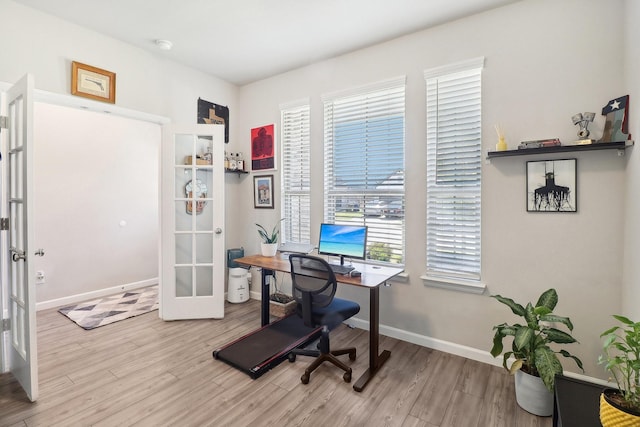 office space with french doors, baseboards, and wood finished floors