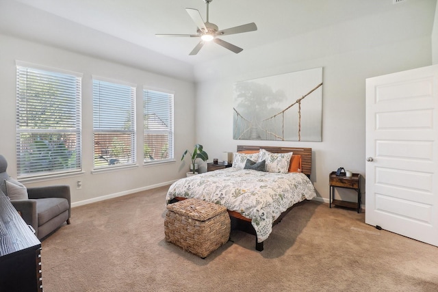 bedroom featuring baseboards, light colored carpet, and a ceiling fan