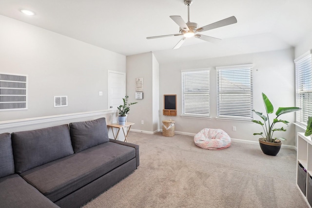 carpeted living room featuring baseboards, visible vents, and ceiling fan