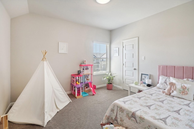 bedroom with lofted ceiling, baseboards, and carpet floors