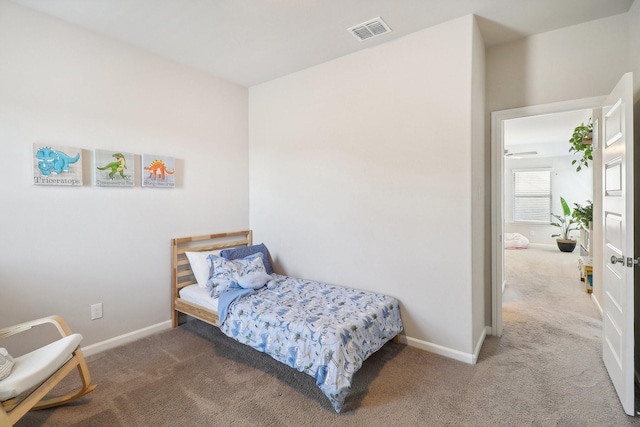 carpeted bedroom featuring visible vents and baseboards