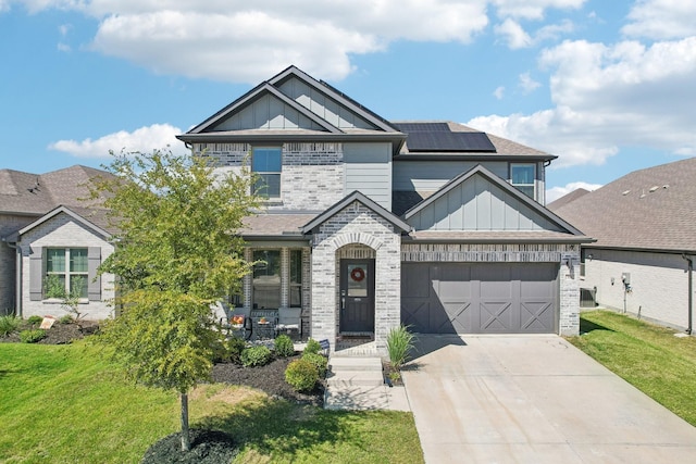 craftsman house with brick siding, board and batten siding, and concrete driveway