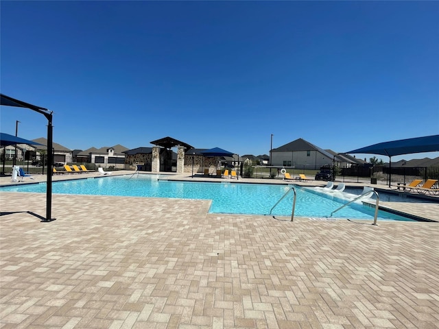 community pool featuring a patio area and fence