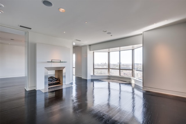 unfurnished living room featuring visible vents, recessed lighting, a fireplace, and wood finished floors